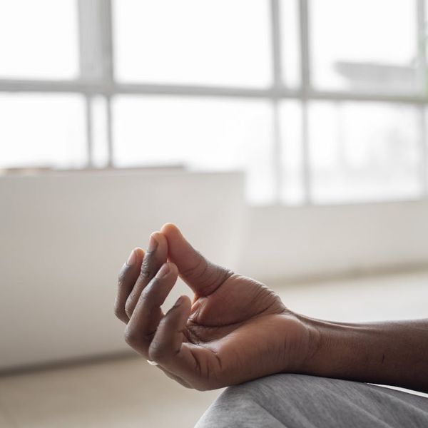 Person meditating peacefully in a bright, clean room.